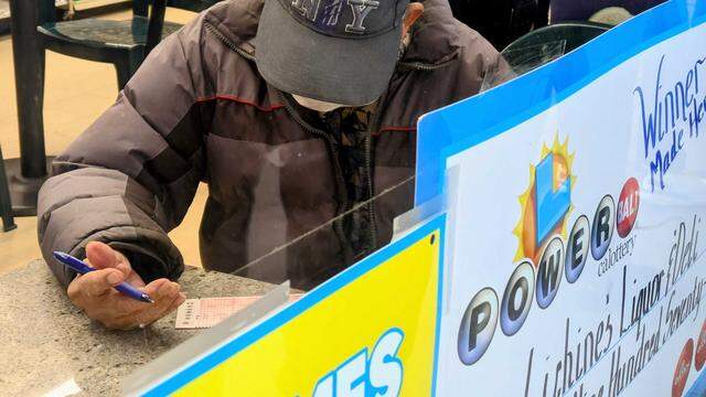 A Powerball hopeful fills out his playslip inside Lichine’s Liquor & Deli on Friday, Dec. 19, 2025. The California State Lottery has raised more than $48 billion for public schools since 1985.